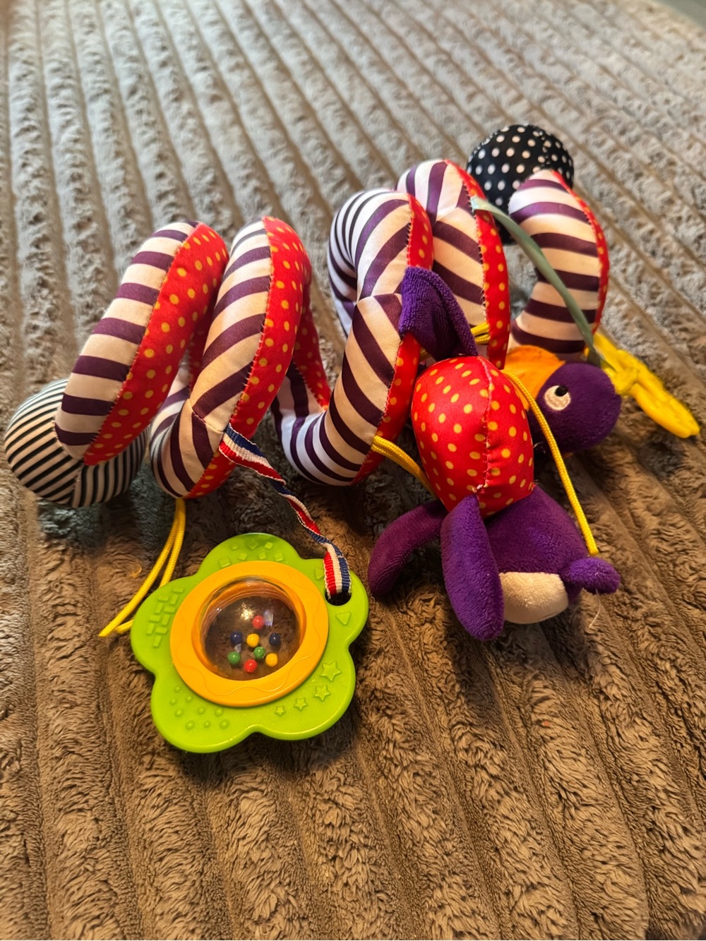 Plush Spiral Car seat Toy in Purple & Red with Rattle
